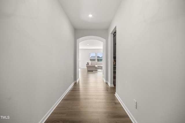 hallway with dark wood-type flooring