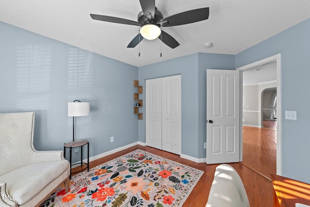 sitting room featuring hardwood / wood-style flooring and ceiling fan