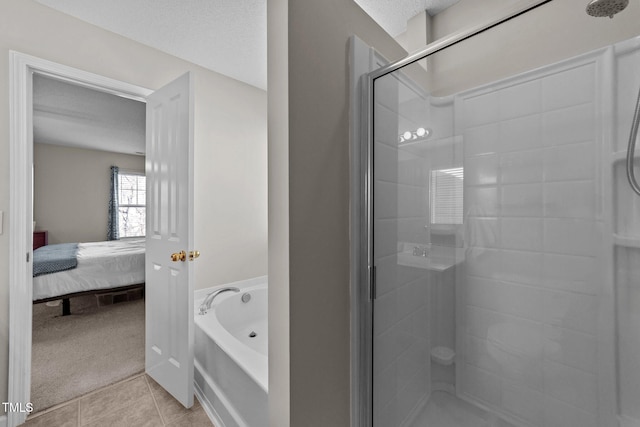 bathroom featuring tile patterned floors, shower with separate bathtub, and a textured ceiling