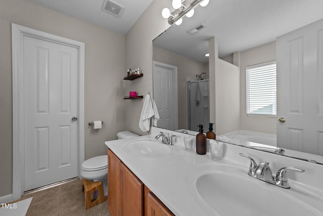 full bathroom with shower with separate bathtub, tile patterned flooring, vanity, toilet, and a textured ceiling