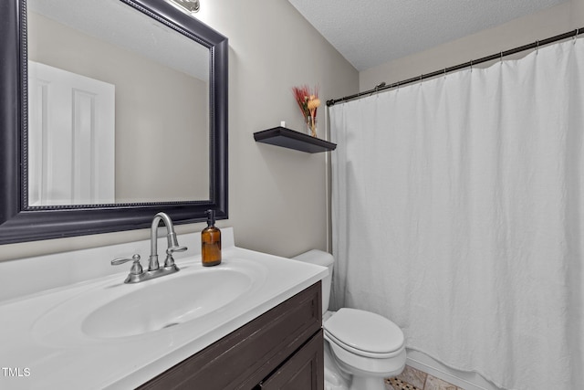 bathroom featuring vanity, toilet, and a textured ceiling