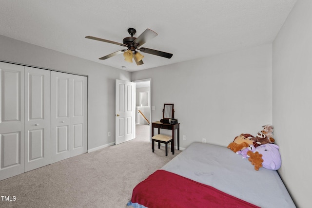 carpeted bedroom featuring ceiling fan and a closet