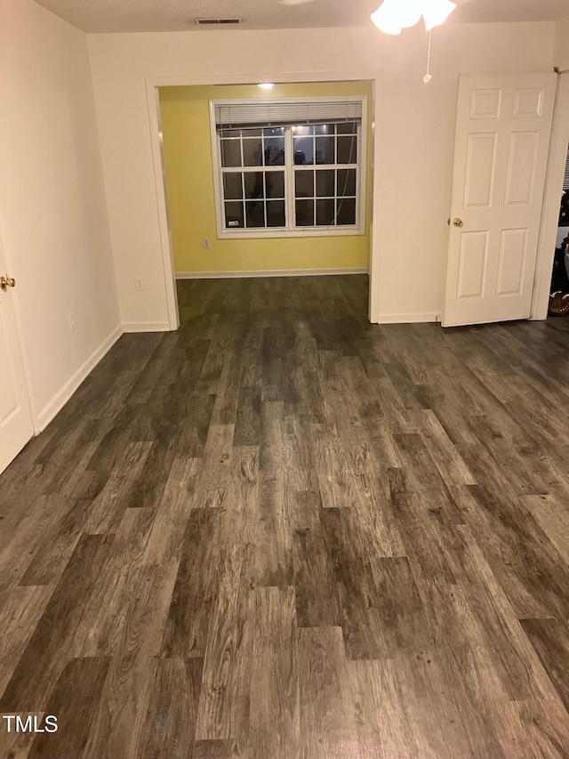 spare room featuring dark hardwood / wood-style floors