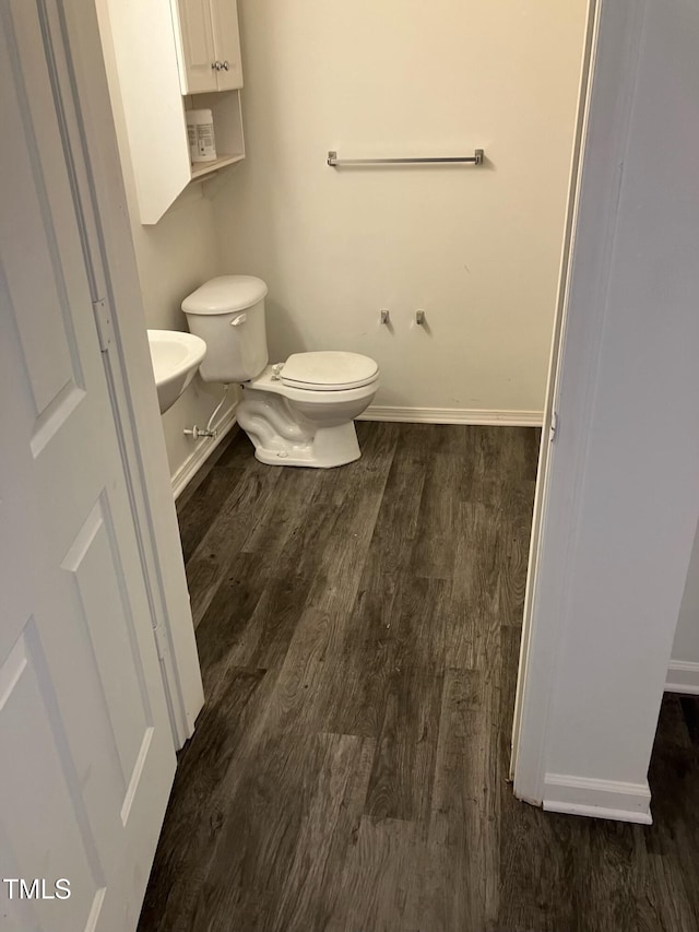 bathroom with toilet and hardwood / wood-style floors