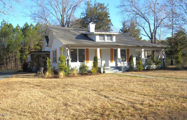 view of front of home featuring a front yard and covered porch