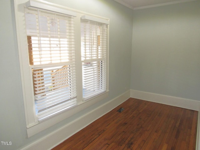 unfurnished room with ornamental molding and dark hardwood / wood-style floors