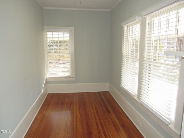 unfurnished room with crown molding and dark hardwood / wood-style floors