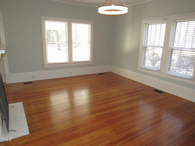 unfurnished dining area with crown molding and wood-type flooring