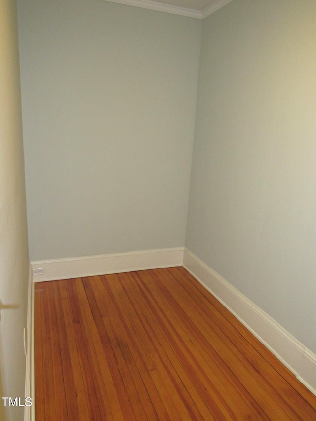 unfurnished room with ornamental molding and hardwood / wood-style floors