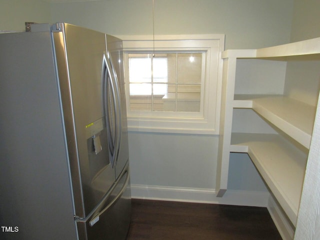 interior space featuring stainless steel refrigerator with ice dispenser and dark hardwood / wood-style flooring