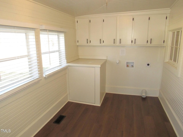 washroom with dark wood-type flooring, gas dryer hookup, cabinets, washer hookup, and hookup for an electric dryer