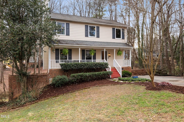 view of front property with covered porch and a front yard