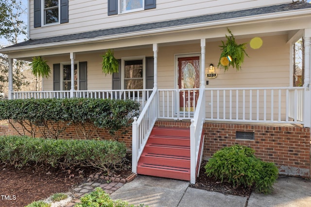 view of exterior entry with a porch