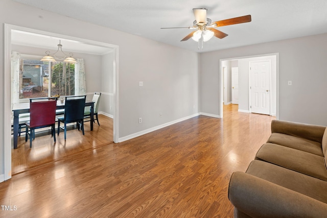 living room with ceiling fan and wood-type flooring