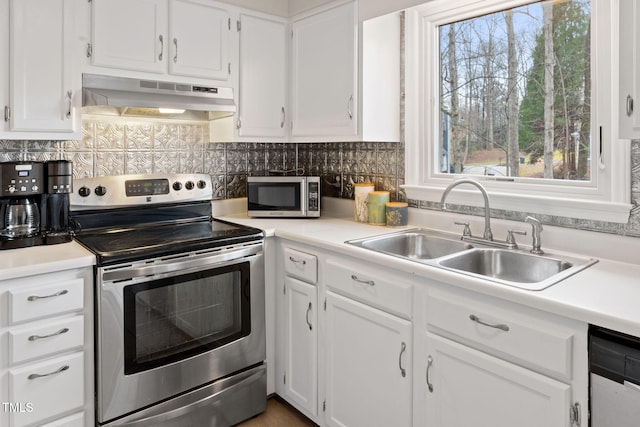 kitchen with sink, stainless steel appliances, white cabinetry, and tasteful backsplash