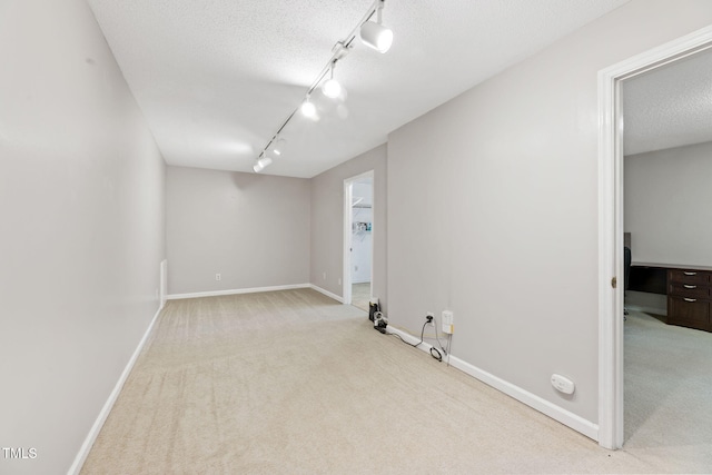 interior space featuring track lighting and a textured ceiling