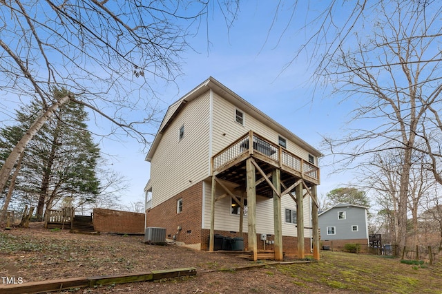 rear view of property with cooling unit and a wooden deck