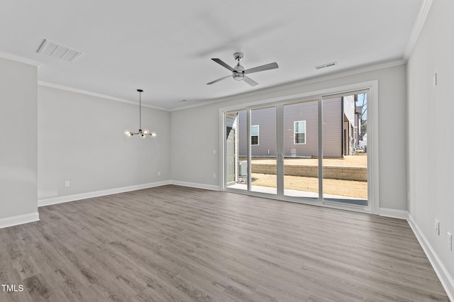 608 Marshskip Way, Rolesville, NC 27587 - unfurnished room featuring crown molding, wood finished floors, a ceiling fan, baseboards, and a chandelier