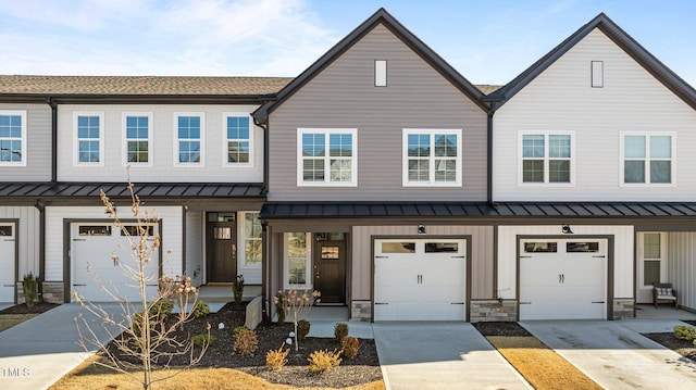 608 Marshskip Way, Rolesville, NC 27587 - townhome / multi-family property featuring a standing seam roof, driveway, stone siding, and metal roof