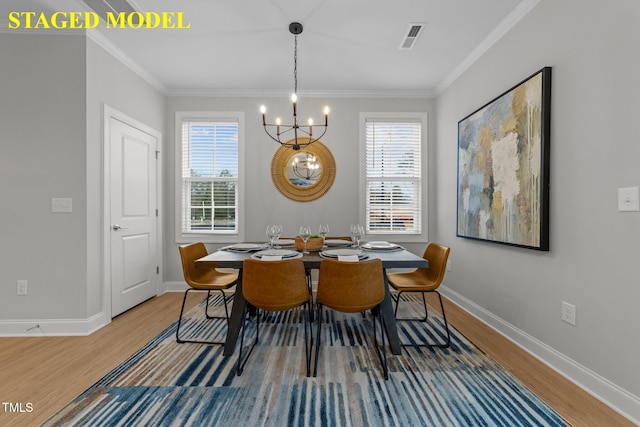 608 Marshskip Way, Rolesville, NC 27587 - dining space with wood finished floors, a chandelier, baseboards, plenty of natural light, and ornamental molding