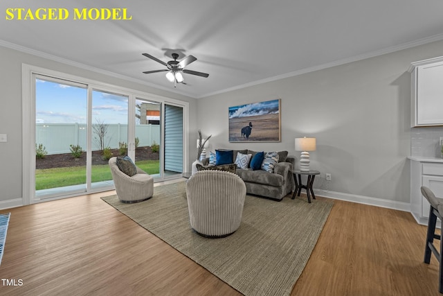 608 Marshskip Way, Rolesville, NC 27587 - living area featuring light wood-style flooring, baseboards, ornamental molding, and ceiling fan