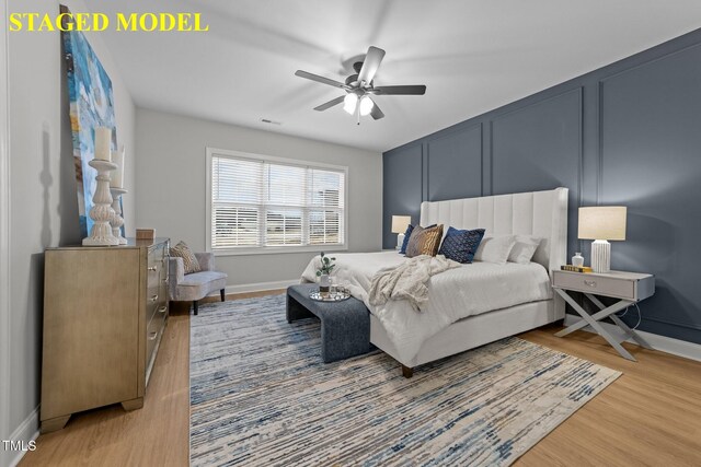 608 Marshskip Way, Rolesville, NC 27587 - bedroom with wood finished floors, baseboards, a decorative wall, and ceiling fan