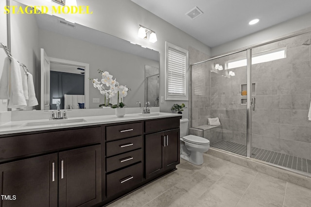 608 Marshskip Way, Rolesville, NC 27587 - full bathroom featuring double vanity, a shower stall, and toilet