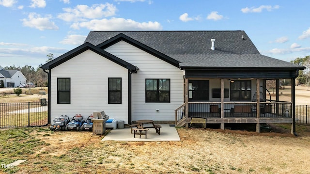 back of house with a patio area and a lawn