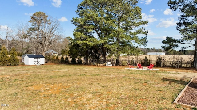 view of yard featuring an outdoor fire pit and a shed