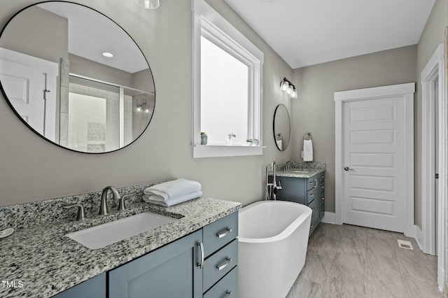 bathroom featuring vanity and separate shower and tub