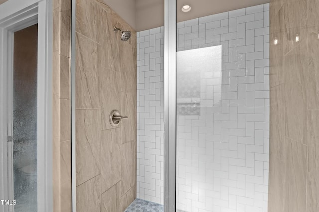 bathroom with a tile shower