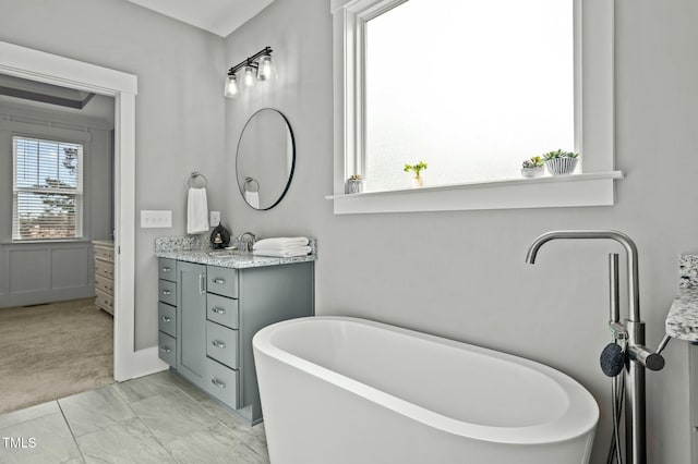 bathroom with a bathing tub and vanity