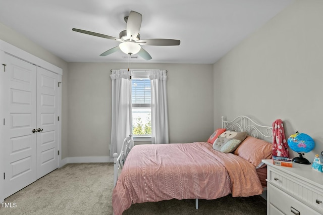 bedroom featuring ceiling fan, a closet, and light carpet