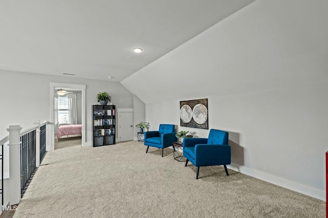 living area featuring vaulted ceiling and carpet floors