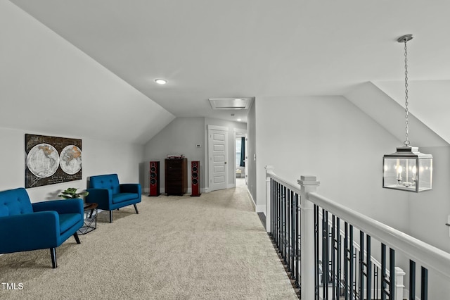 sitting room with vaulted ceiling and light carpet