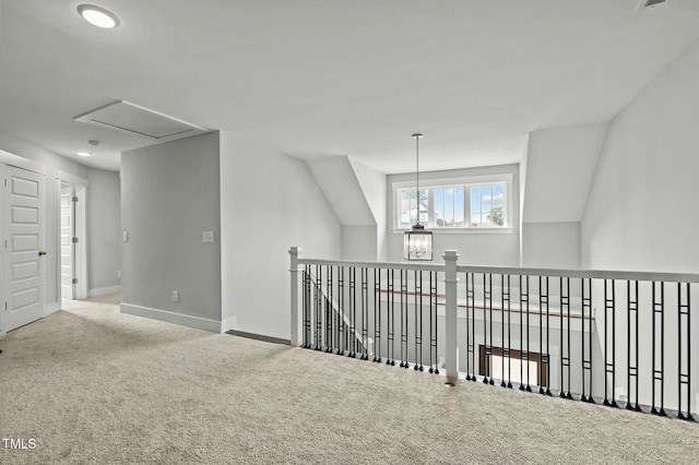 hallway featuring carpet flooring and a chandelier