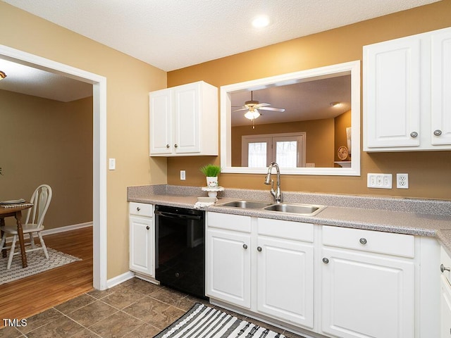 kitchen featuring sink, ceiling fan, white cabinetry, black dishwasher, and dark tile patterned flooring