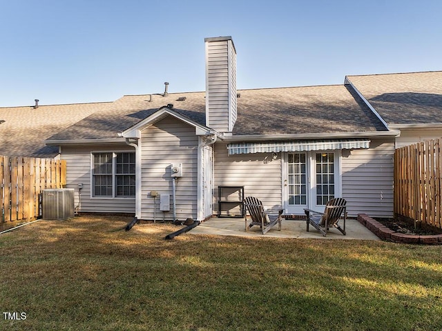 rear view of house featuring a yard, a patio area, french doors, and central air condition unit