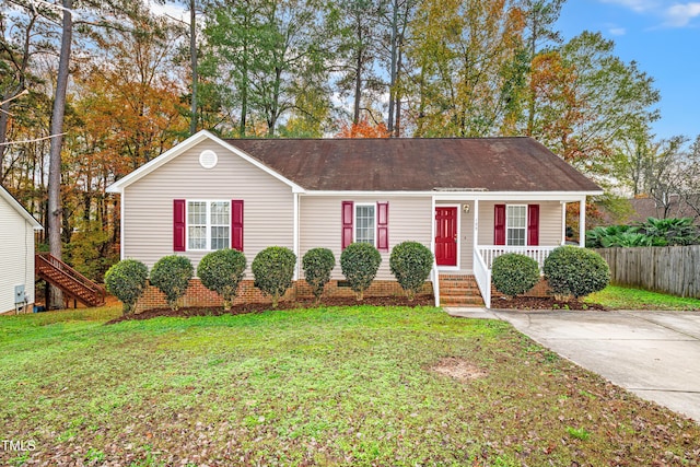 single story home featuring covered porch and a front lawn