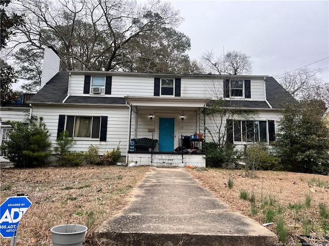 front of property featuring cooling unit and covered porch