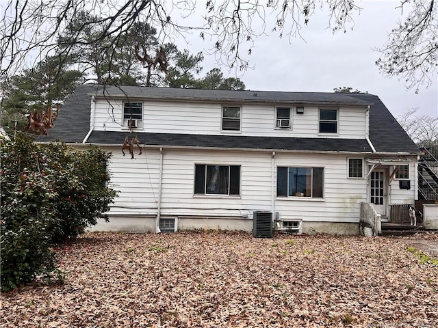 back of house with central air condition unit