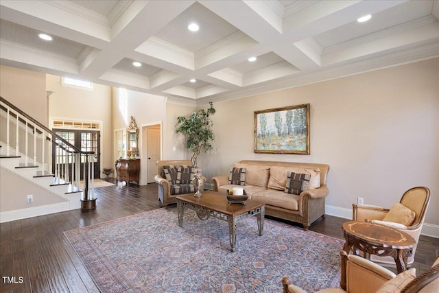 living room featuring dark wood-type flooring, ornamental molding, coffered ceiling, and beam ceiling