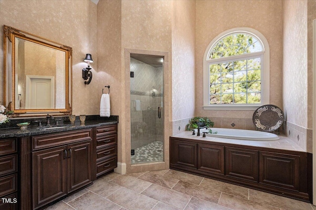 bathroom with independent shower and bath and vanity