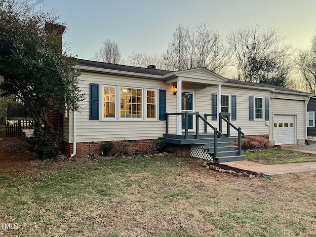 view of front of home featuring a garage and a lawn