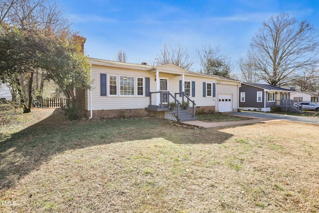 view of front of house featuring a garage and a front yard