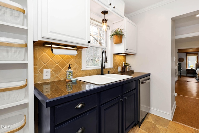 kitchen with decorative light fixtures, white cabinetry, sink, stainless steel dishwasher, and crown molding