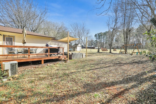 view of yard with cooling unit and a deck