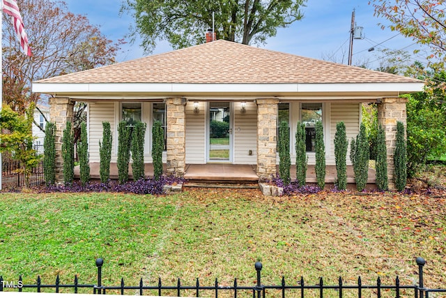 view of front of property with covered porch and a front lawn