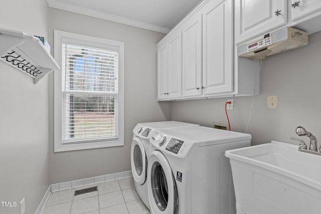 laundry room featuring light tile patterned flooring, sink, crown molding, cabinets, and independent washer and dryer