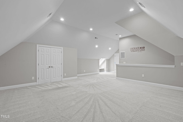 bonus room featuring lofted ceiling and light colored carpet